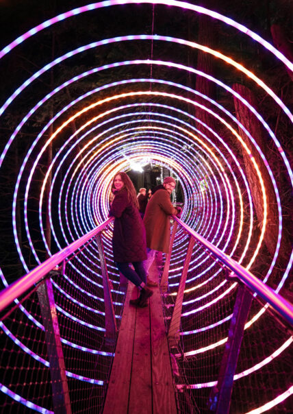 Young couple at the Arc de Lumina on Cliffwalk during Love Lights at Capilano Suspension Bridge Park