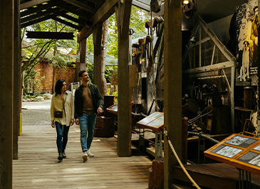 two guests walking in the story centre at capilano suspension bridge park