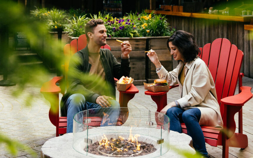 two guests eating burgers and fries from the Loggers' Grill at Capilano Suspension Bridge Park