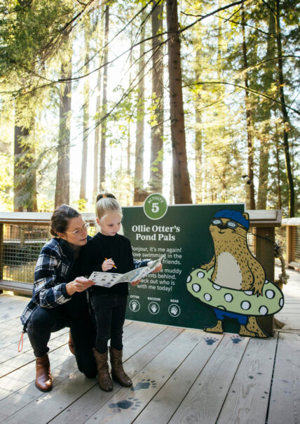 Mother with her daughter playing the Kids Rainforest Explorer activity at Capilano Suspension Bridge Park